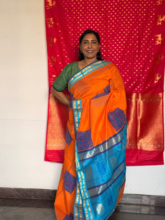 Orange silk cotton saree with block print
